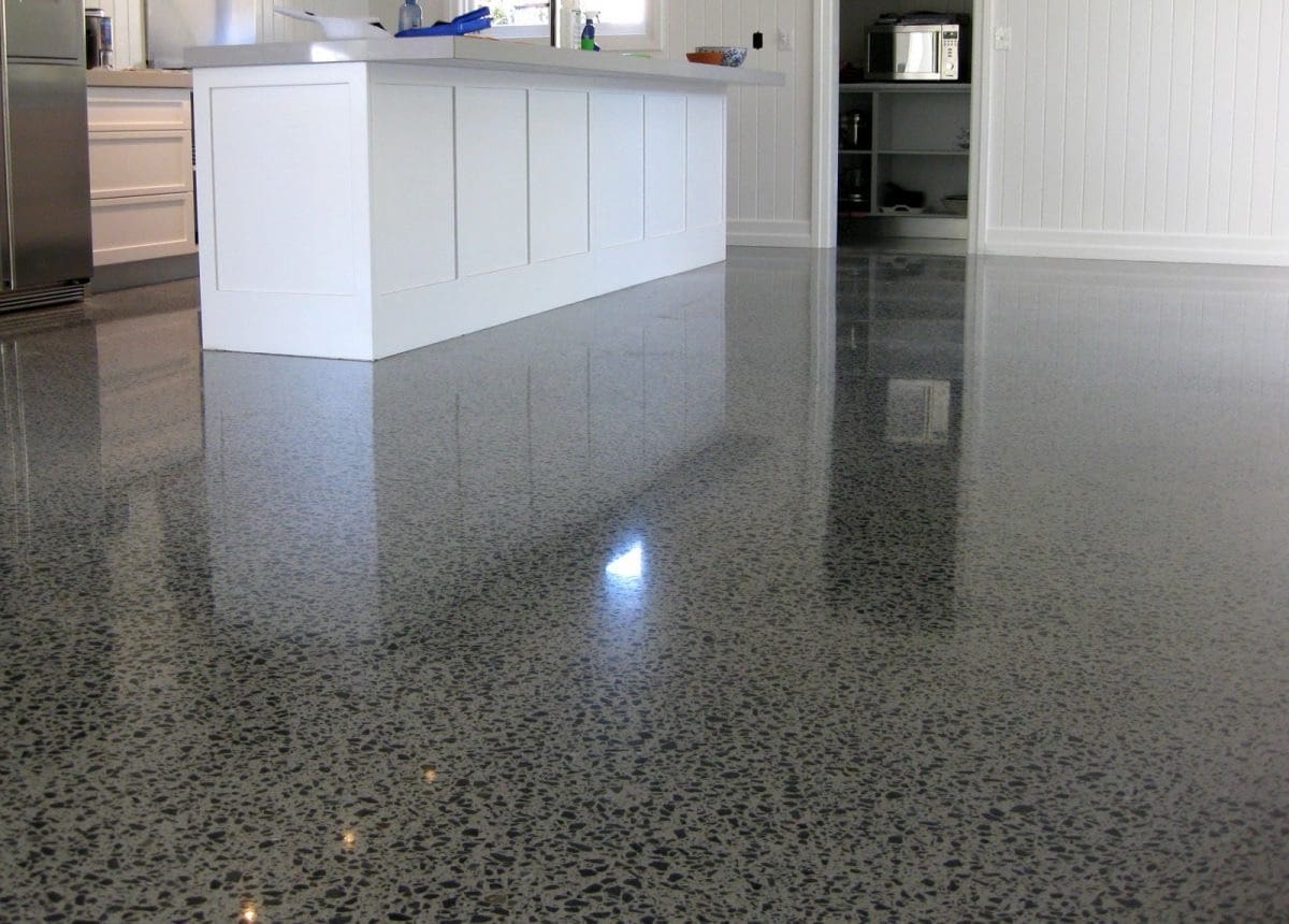 A kitchen with a shiny floor and white cabinets.