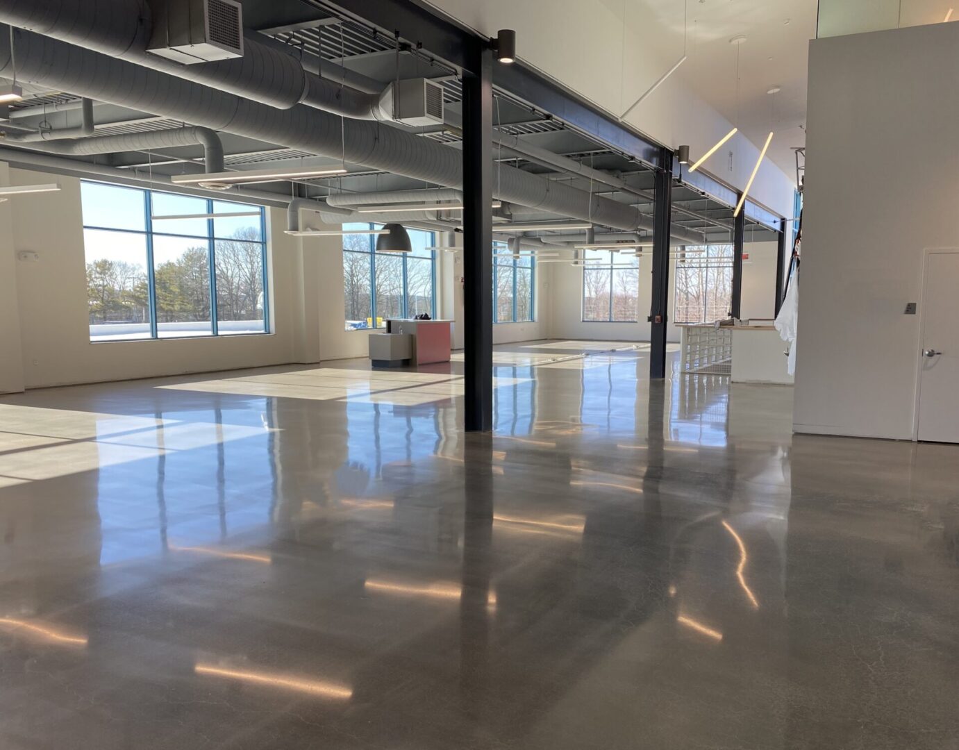 A large room with shiny floors and windows.